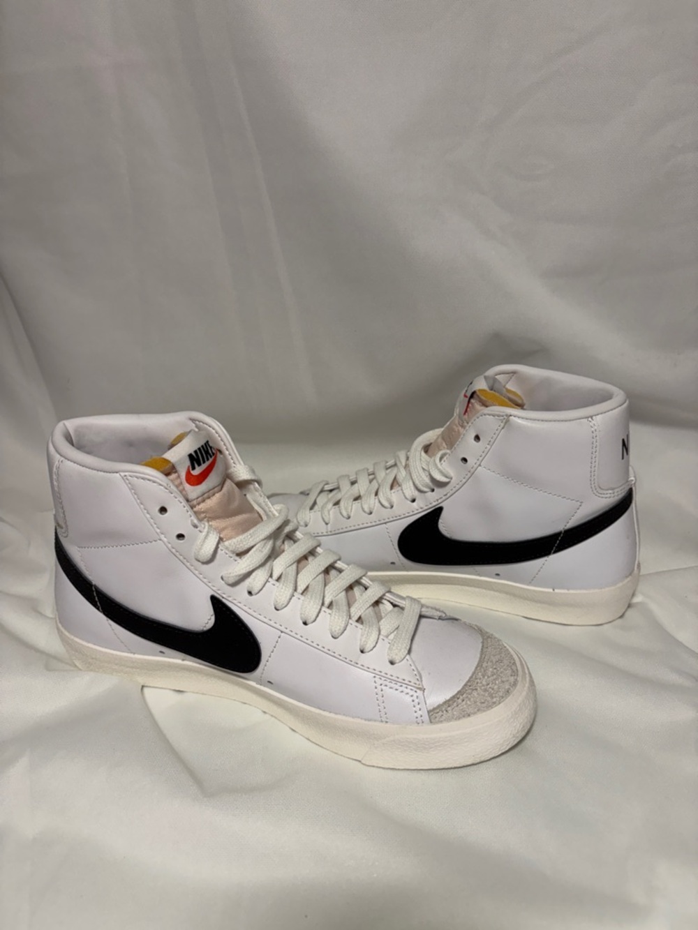 Nike White High-Top Sneakers with Black Swoosh